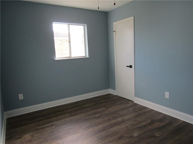 unfurnished room featuring ceiling fan and dark hardwood / wood-style floors