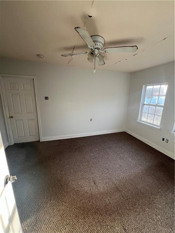 carpeted empty room with ceiling fan