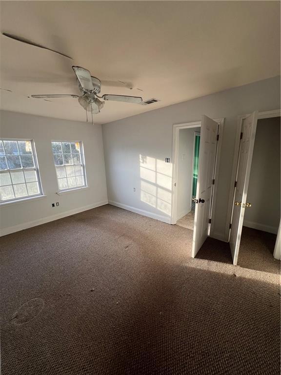 unfurnished bedroom with ceiling fan and carpet flooring