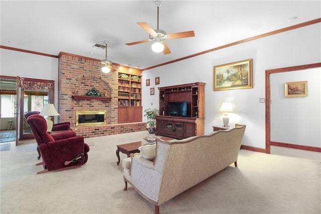 carpeted living room with built in shelves, ceiling fan, crown molding, and a brick fireplace