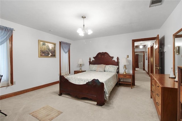 carpeted bedroom featuring an inviting chandelier