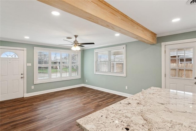 interior space with ceiling fan, crown molding, dark wood-type flooring, and beamed ceiling