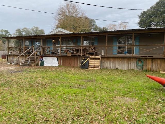 rear view of house with a lawn