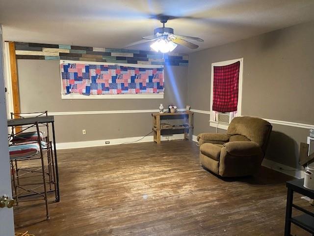 sitting room featuring dark hardwood / wood-style floors and ceiling fan