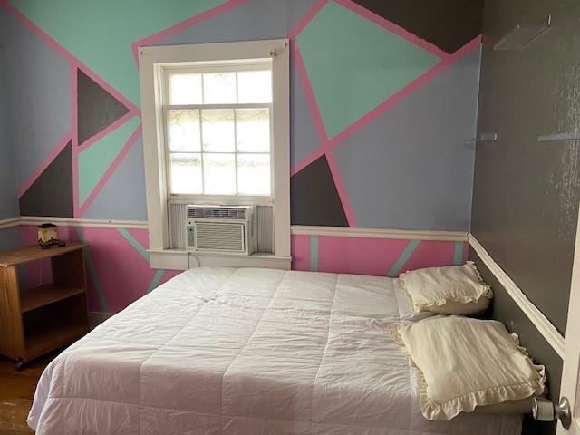 bedroom featuring cooling unit and hardwood / wood-style floors