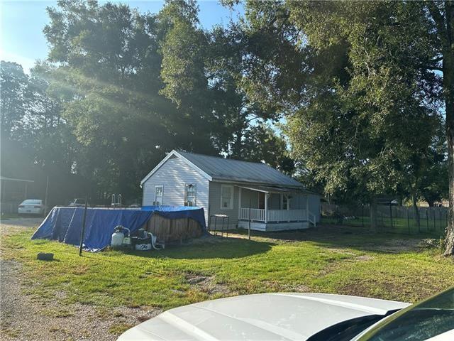 view of yard with a porch and a covered pool