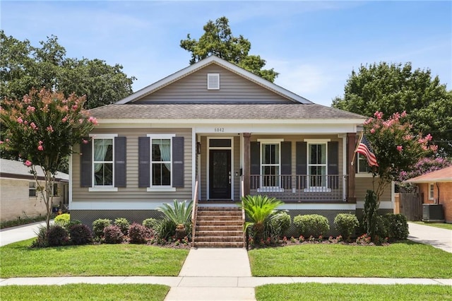 view of front of property featuring central AC, a front yard, and a porch