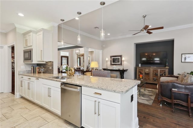 kitchen with hanging light fixtures, ornamental molding, dishwasher, light stone countertops, and white cabinets