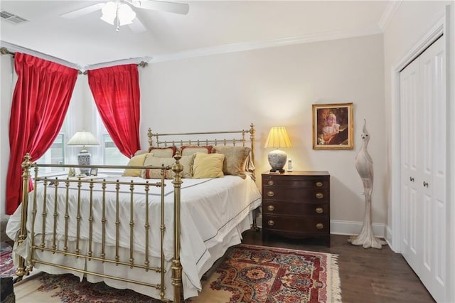 bedroom featuring dark hardwood / wood-style flooring, crown molding, a closet, and ceiling fan