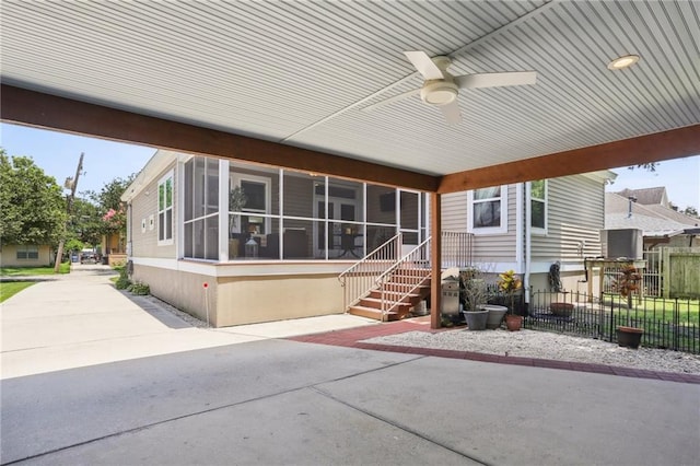 exterior space with ceiling fan and a sunroom