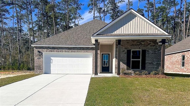 view of front of property with driveway, board and batten siding, an attached garage, brick siding, and a front lawn