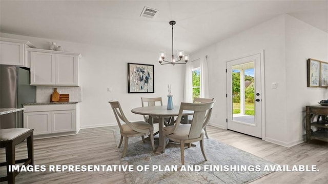 dining space with baseboards, visible vents, an inviting chandelier, and light wood-style floors