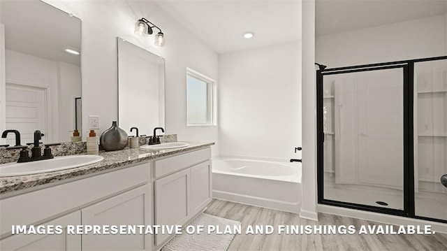 full bathroom with wood finished floors, a garden tub, a stall shower, and a sink