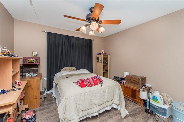 bedroom with hardwood / wood-style floors and ceiling fan