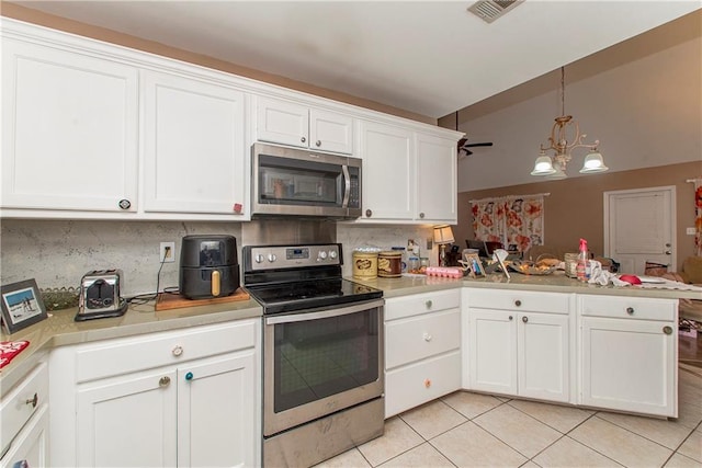 kitchen featuring white cabinetry, decorative backsplash, light tile patterned flooring, and appliances with stainless steel finishes