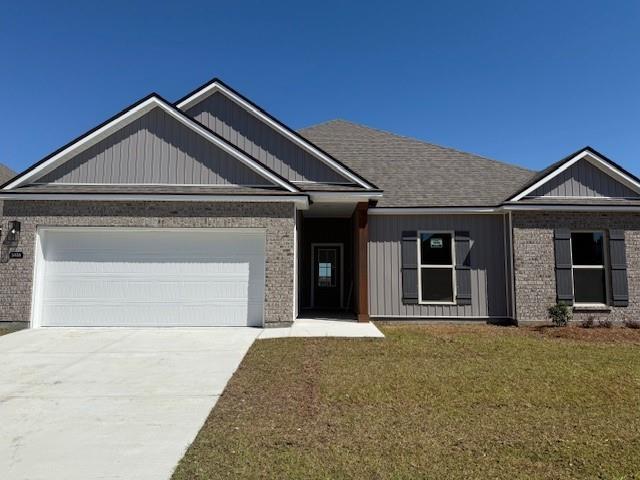 5436 Wake Reserve Rd, Slidell, LA 70461 - view of front facade featuring an attached garage, brick siding, a front yard, and driveway
