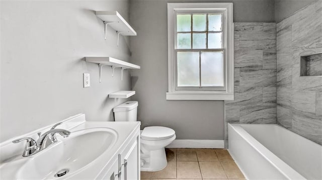 bathroom featuring tile patterned flooring, vanity, toilet, a tub, and baseboards