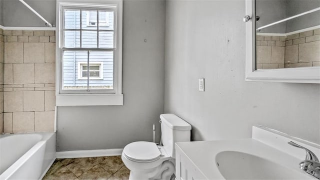 full bath with vanity, toilet, tile patterned floors, shower / bath combination, and baseboards