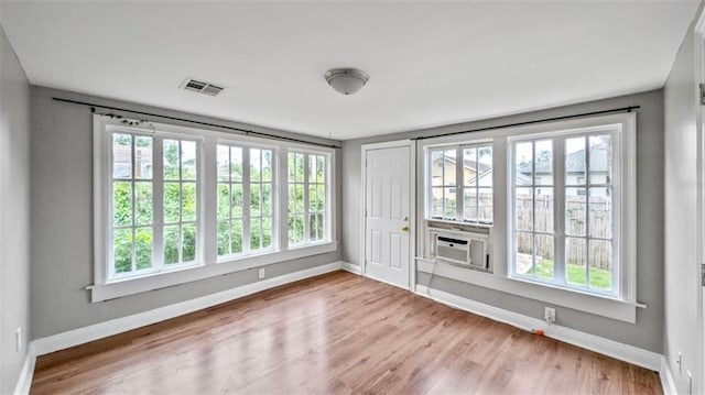 empty room featuring baseboards and plenty of natural light