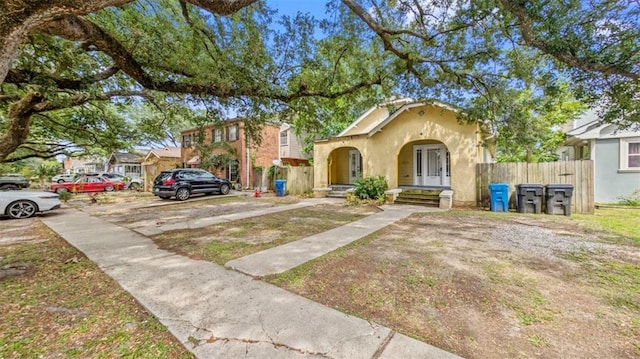 view of front of property featuring stucco siding and fence