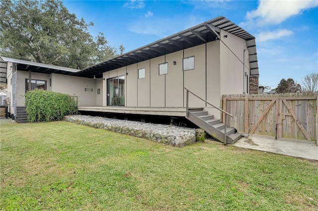 rear view of property with a yard