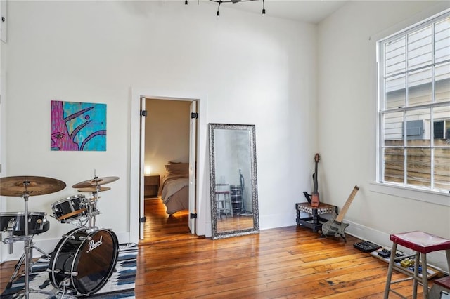 misc room with wood-type flooring and baseboards