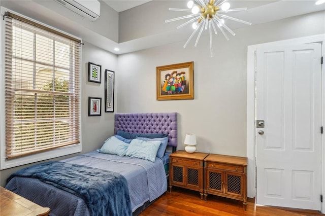 bedroom featuring recessed lighting, ceiling fan with notable chandelier, wood finished floors, and a wall unit AC