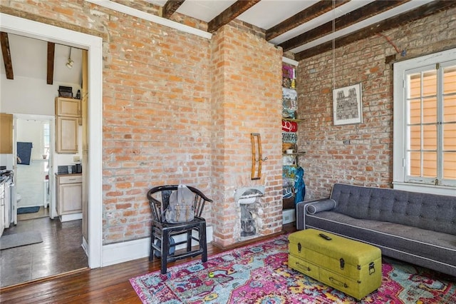living room with brick wall, beam ceiling, and hardwood / wood-style flooring