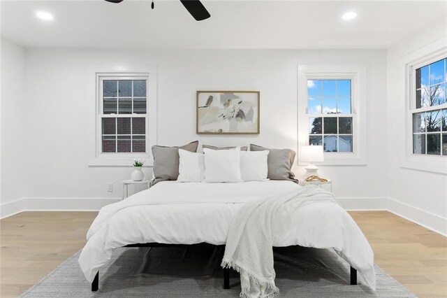 bedroom with ceiling fan and light hardwood / wood-style floors