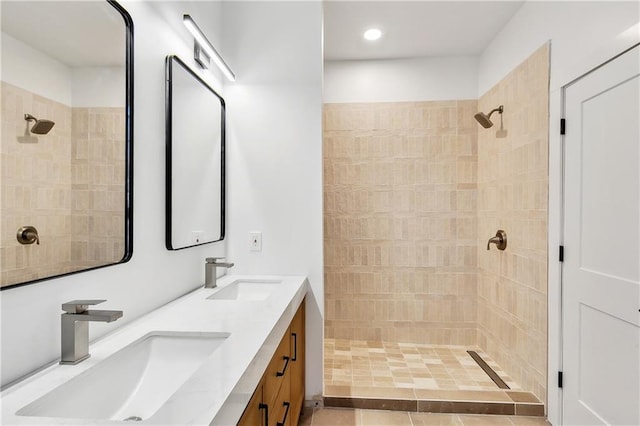 bathroom with vanity and a tile shower