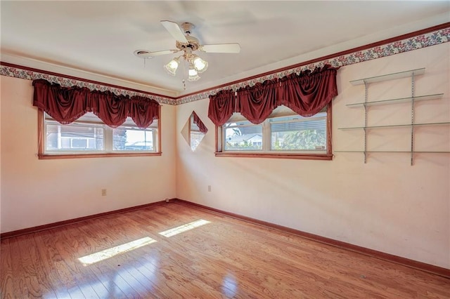 empty room featuring hardwood / wood-style floors and ceiling fan