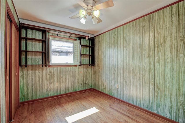 unfurnished room with hardwood / wood-style floors and ceiling fan