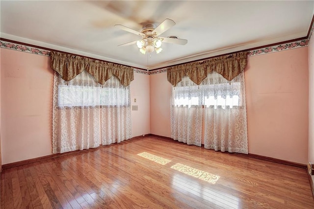 spare room with ceiling fan and hardwood / wood-style floors