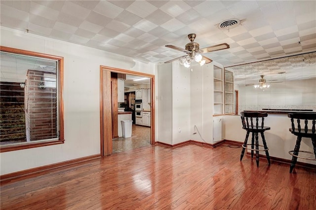 spare room with wood-type flooring and ceiling fan