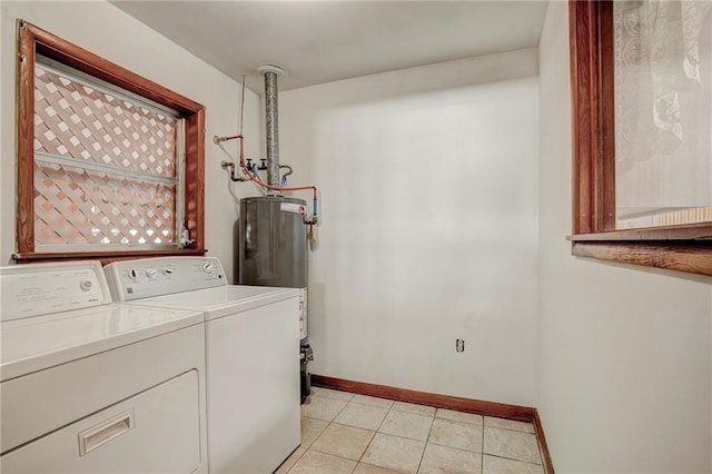 laundry room with washing machine and clothes dryer, light tile patterned floors, and gas water heater