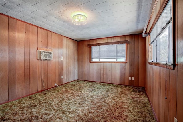 spare room featuring carpet floors, a wall mounted air conditioner, and wooden walls