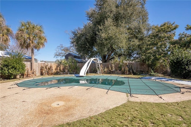 view of swimming pool with a water slide