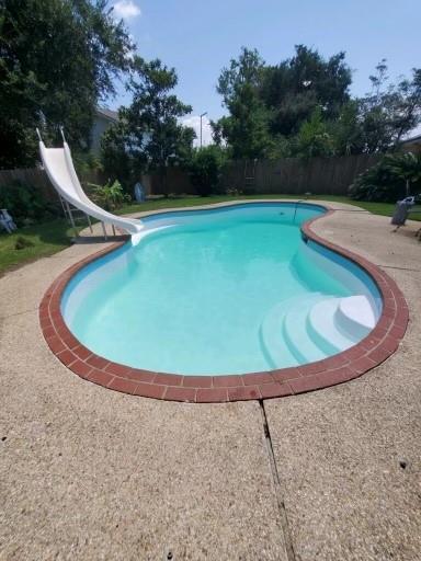 view of pool featuring a patio and a water slide