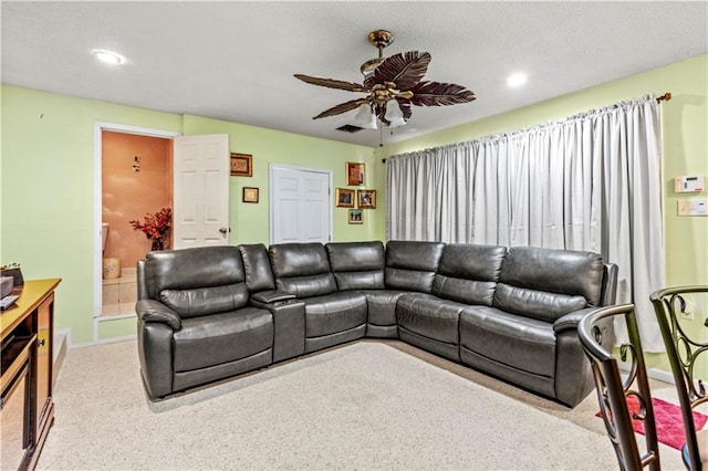 living room with ceiling fan and carpet