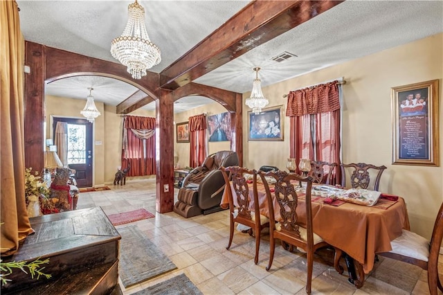 dining space featuring a textured ceiling, beamed ceiling, and a chandelier