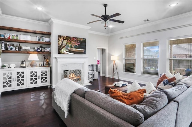 living room with crown molding, ceiling fan, and dark hardwood / wood-style floors