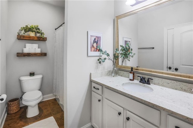 bathroom featuring vanity, tile patterned floors, and toilet