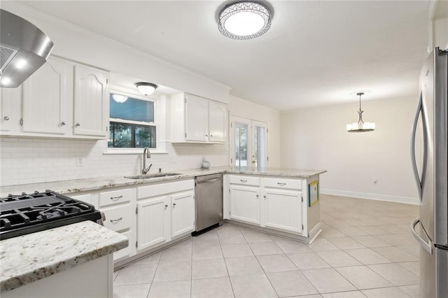 kitchen featuring stainless steel appliances, white cabinetry, sink, and kitchen peninsula