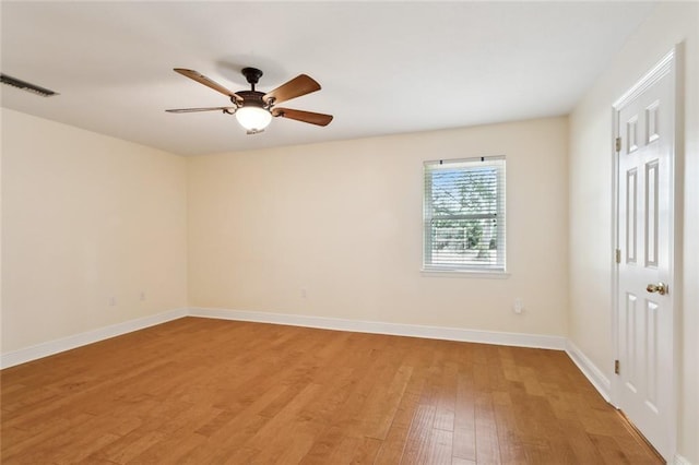 spare room with hardwood / wood-style floors and ceiling fan