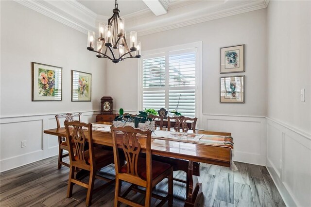 dining space featuring dark wood-type flooring, crown molding, and a notable chandelier