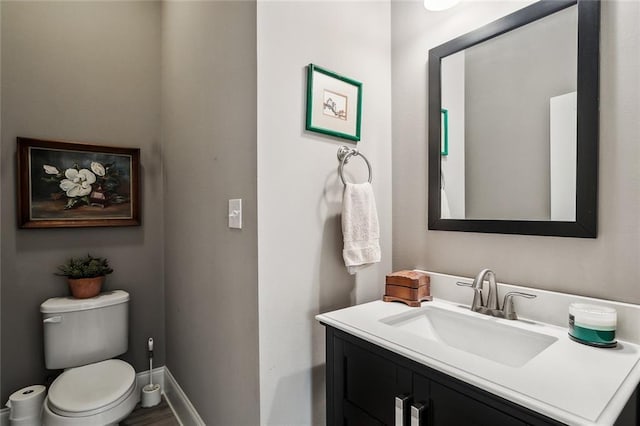 bathroom featuring vanity and toilet