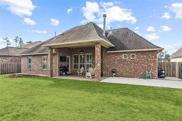 rear view of property featuring a patio, a yard, and ceiling fan