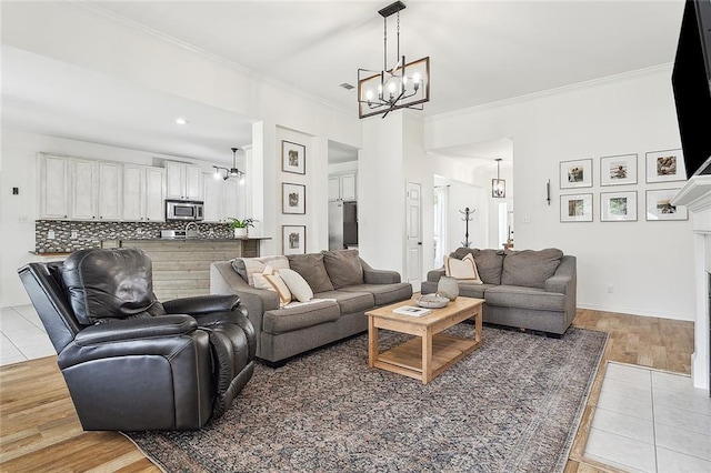 living room featuring crown molding, light tile patterned floors, and a chandelier