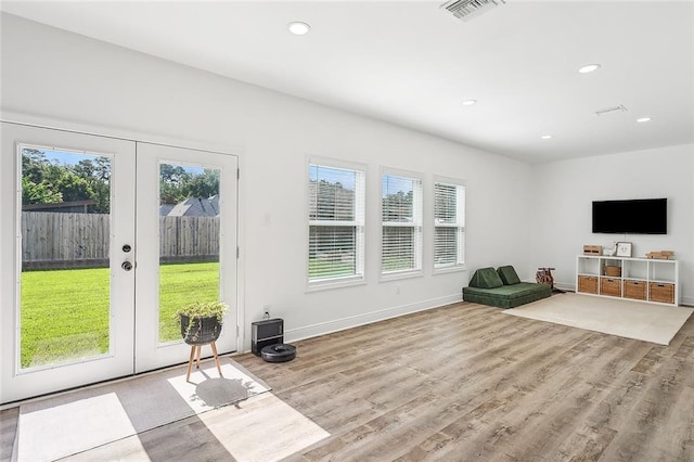 interior space featuring light wood-type flooring and french doors