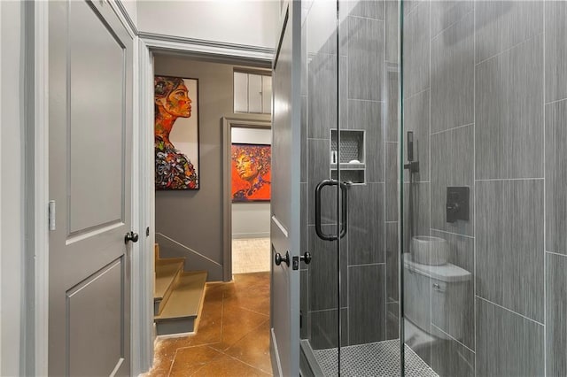 bathroom with a shower with shower door and tile patterned floors